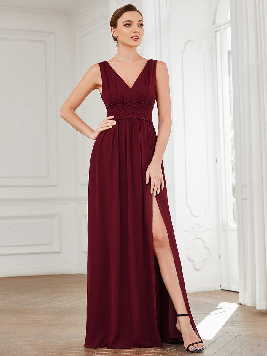Burgundy pleated chiffon V-neck bridesmaid dress with front slit.