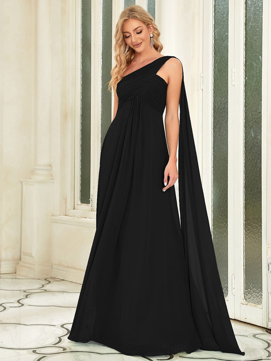 Close-up of the pleated detail on a black Weitese one-shoulder dress.