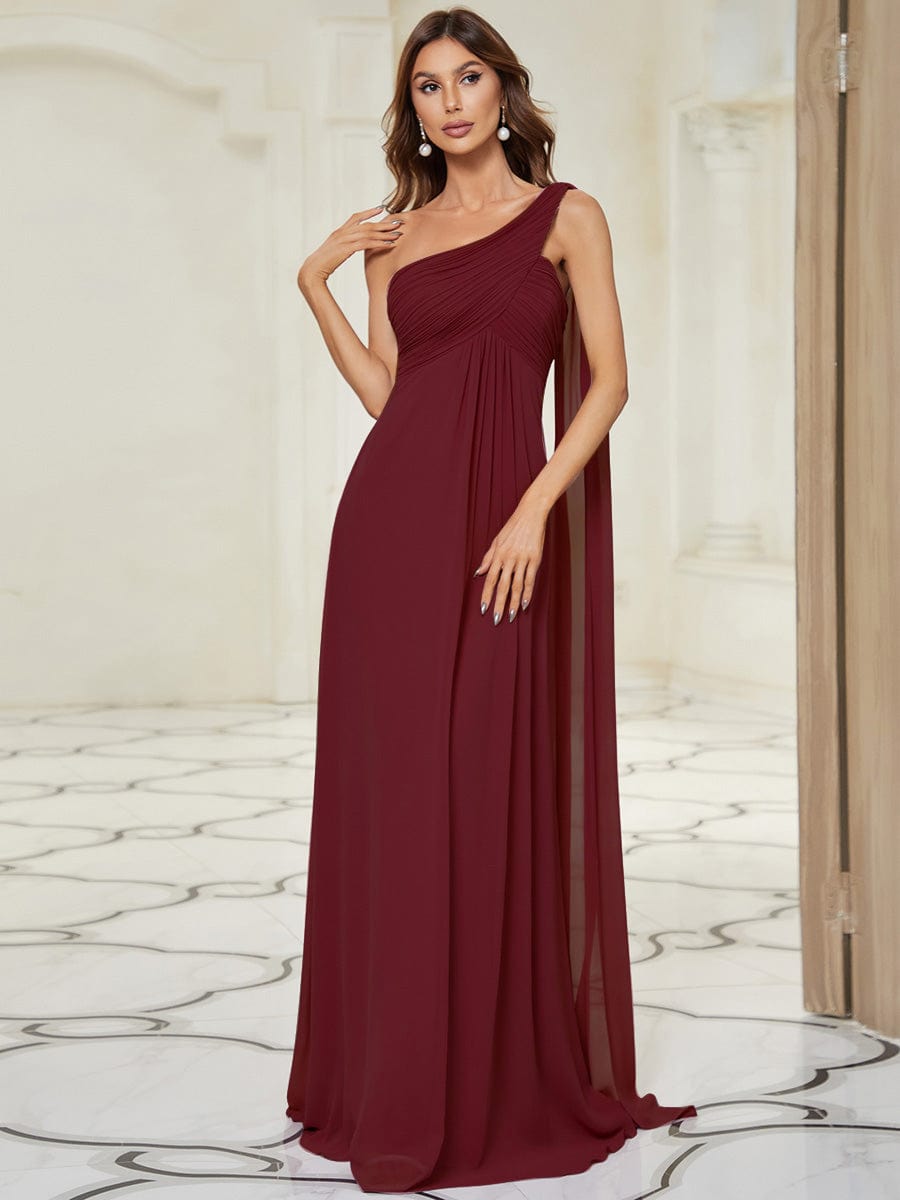 Model wearing a blue Weitese pleated one-shoulder long chiffon evening dress.