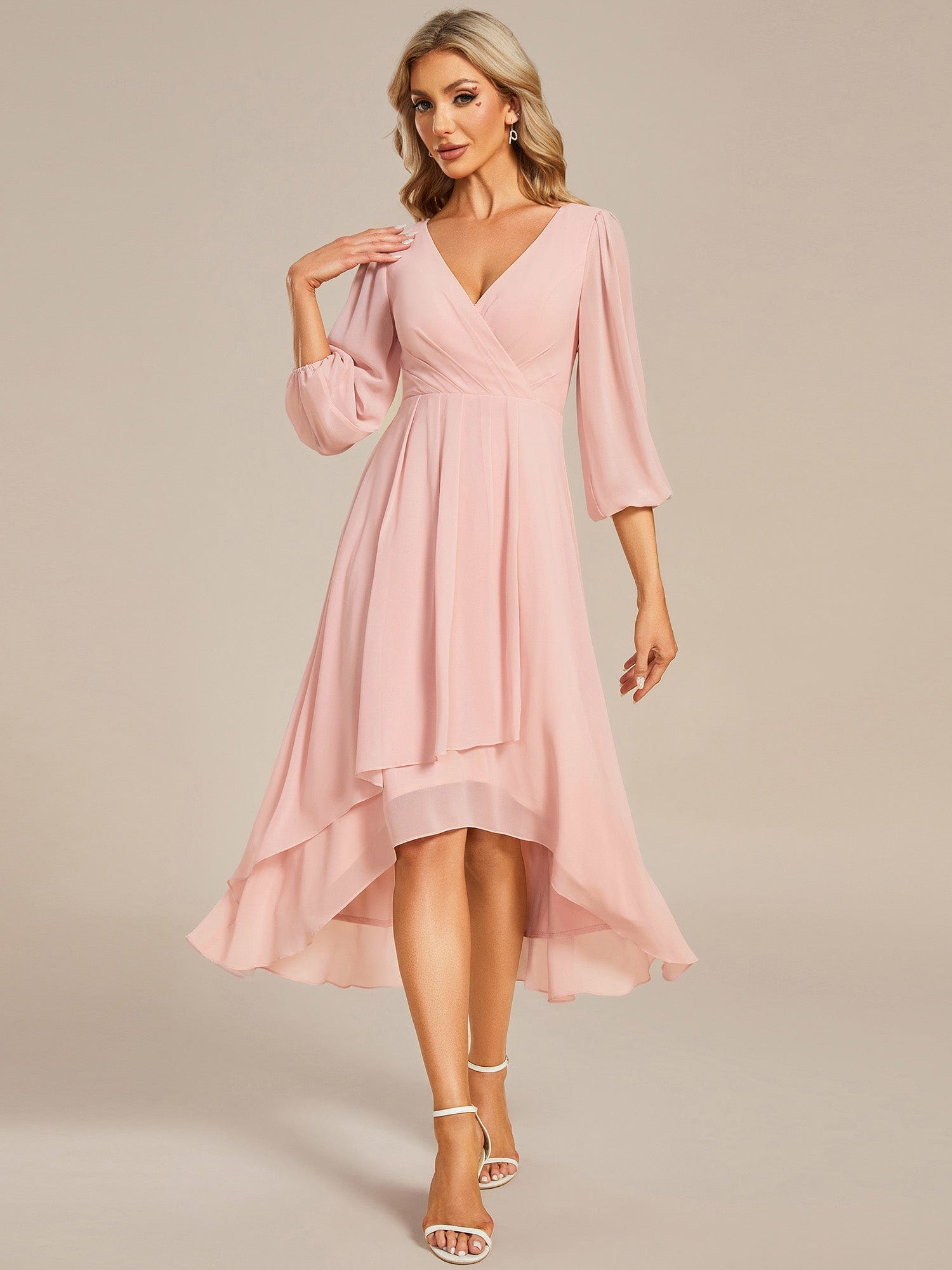 Model wearing a pink Weitese A-line chiffon wedding guest dress with long see-through sleeves and V-neck.