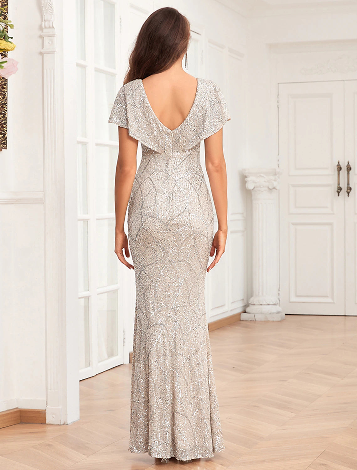 Side view of the elegant sequined mermaid dress on a model.