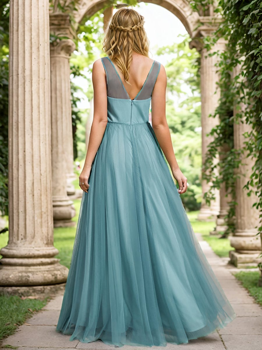 Close-up of the floral decoration and sheer shoulder strap on the dark blue Weitese bridesmaid dress.