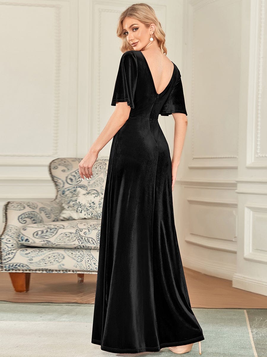 Full length view of a woman in a black velvet elegant party dress.