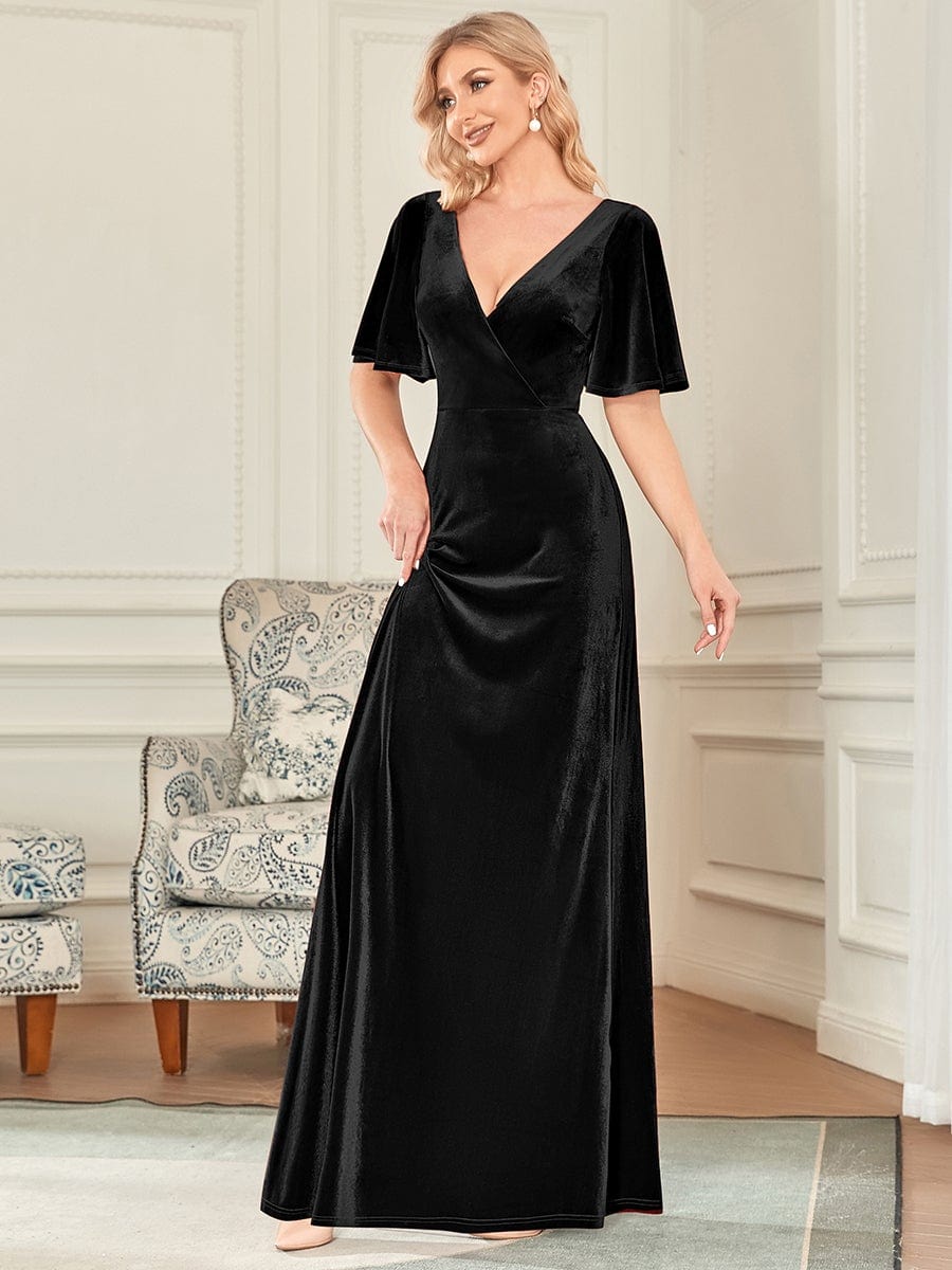 Close-up of the luxurious velvet fabric and double V-neckline of the dress.