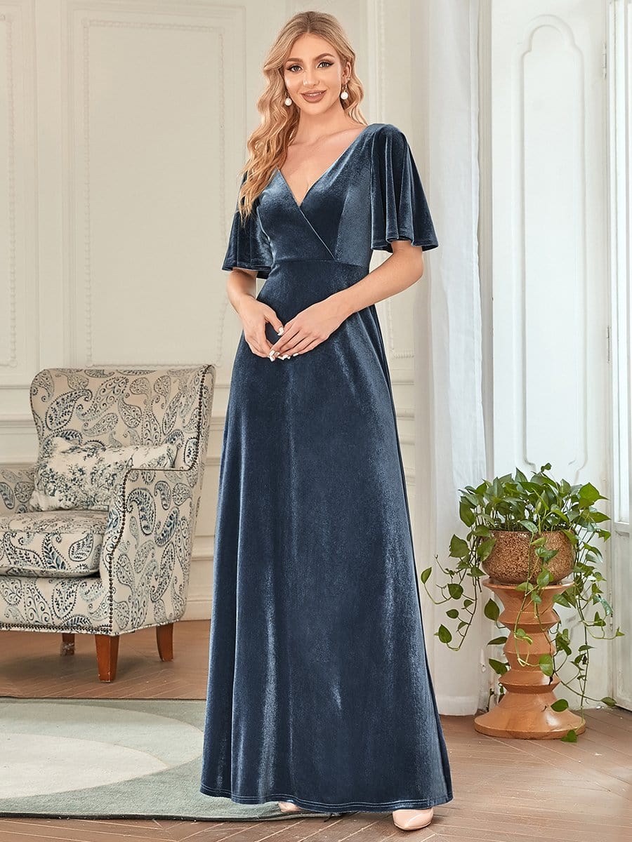 Front view of a woman modeling the dark blue velvet party dress.