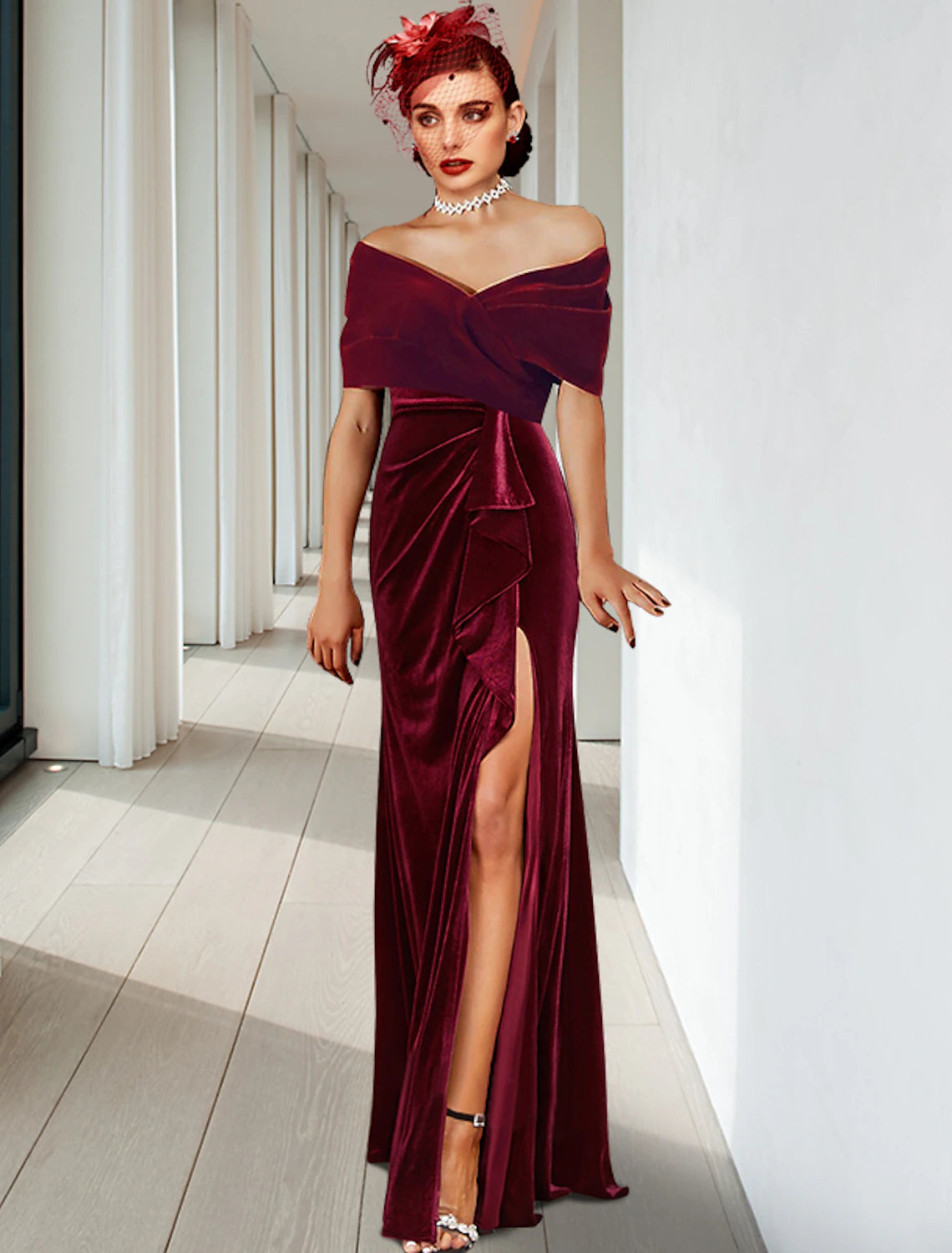A woman wearing a floor-length velvet sheath gown with a V-neck, pleats, and ruffles.