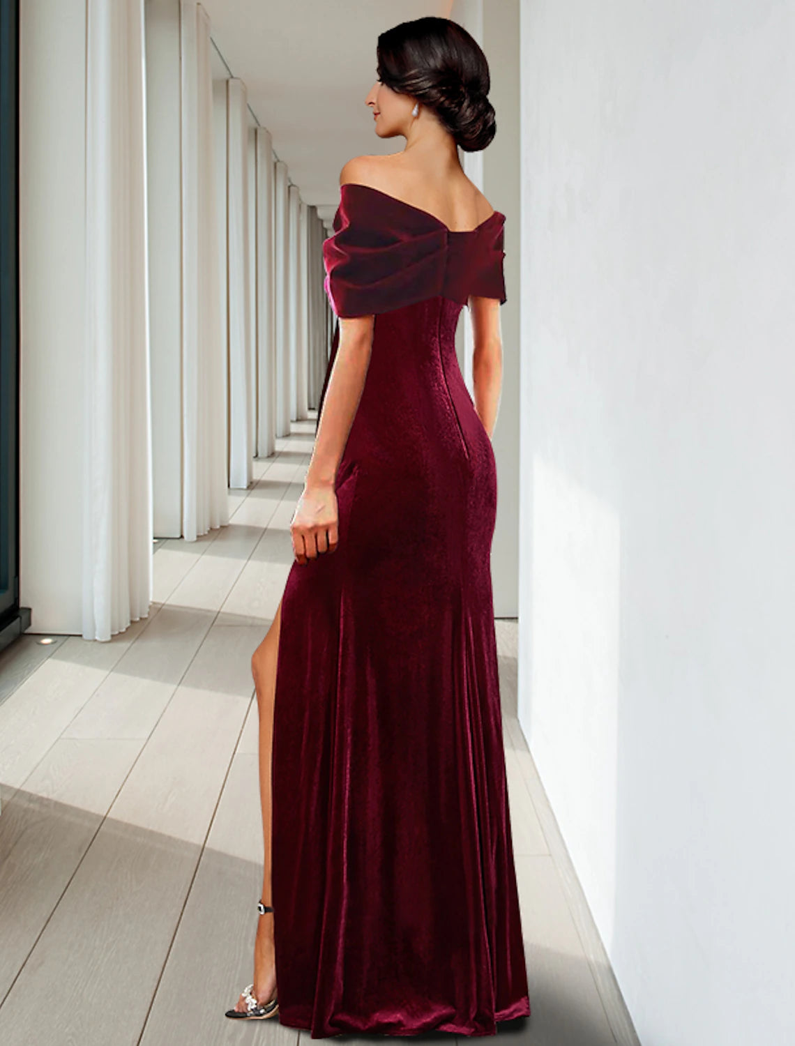 A close-up of the velvet fabric and ruffle details on the elegant V-neck gown.