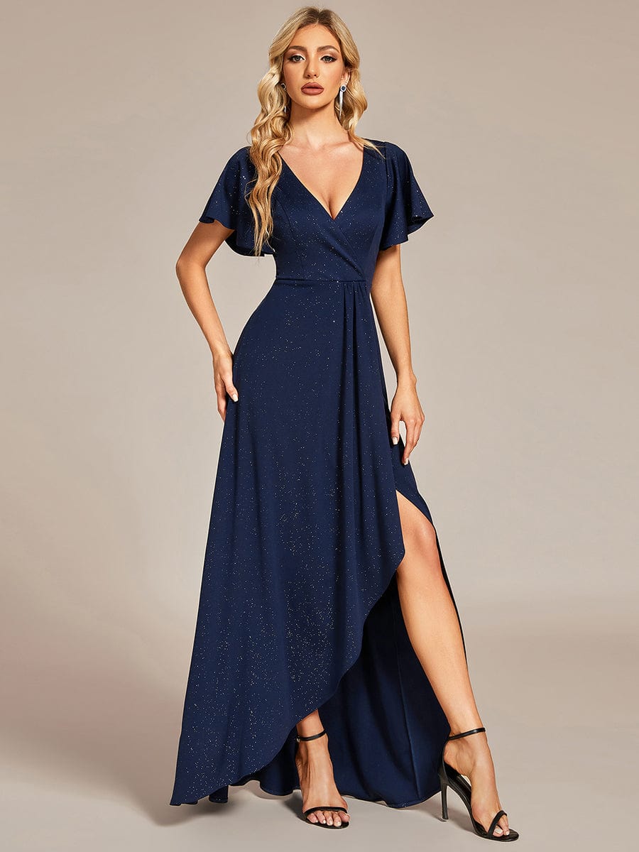 Woman wearing a navy blue Weitese glitter high-low evening dress with ruffled V-neck and side slit.