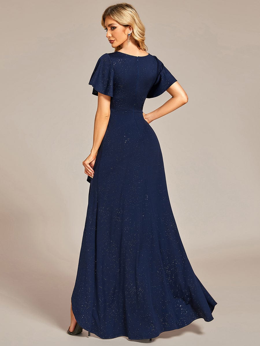 Back view of a woman in a navy blue Weitese glitter high-low evening dress.