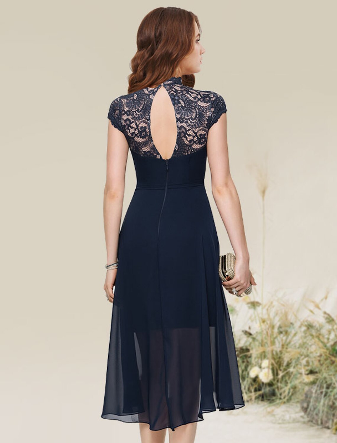 Side profile of a woman in a navy A-line chiffon lace dress.