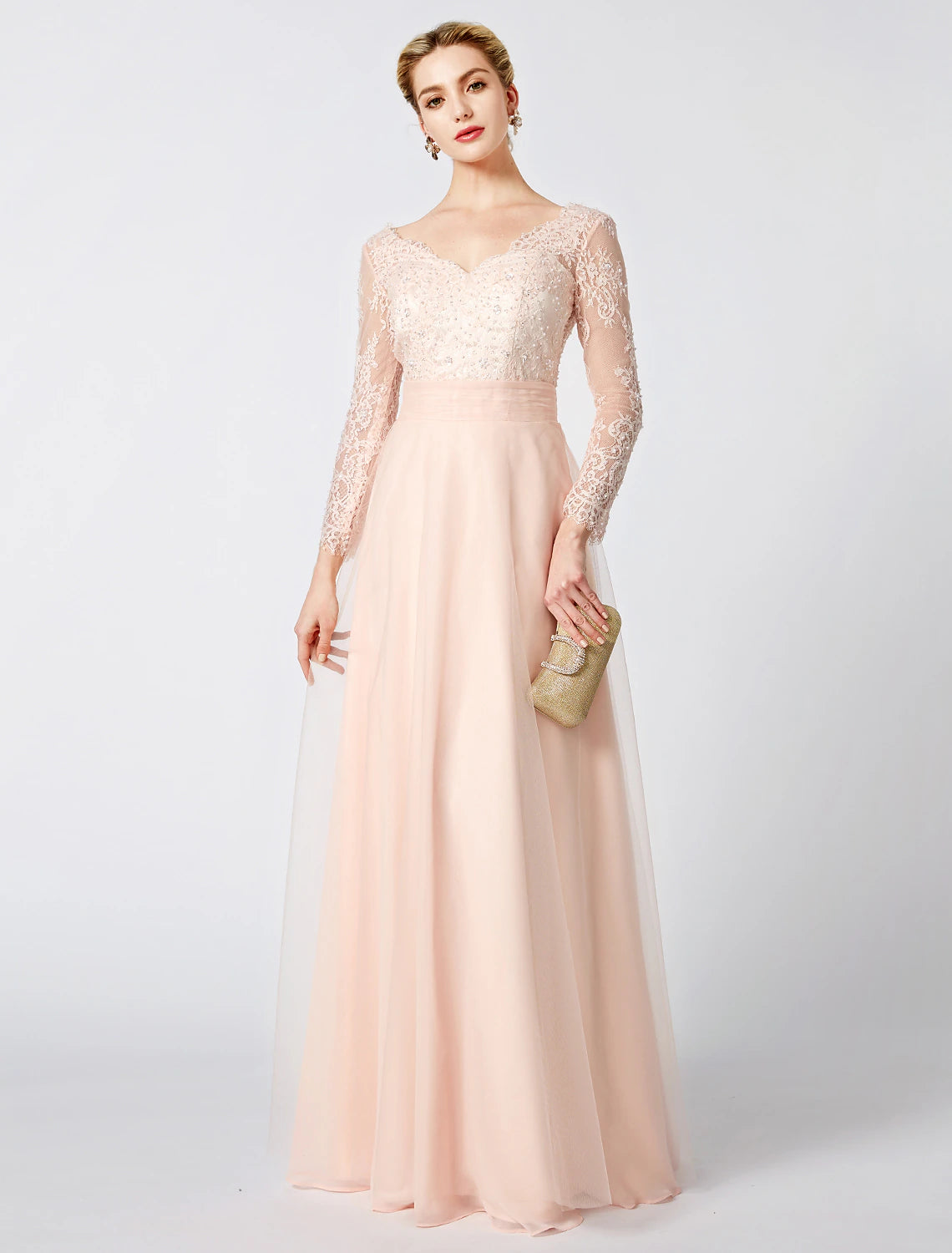 Model wearing a pastel V-neck long sleeve ball gown with tulle skirt and beading.