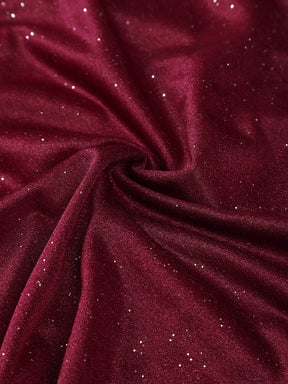 Close-up of the blue glitter fabric and pleated detail on the A-line dress.