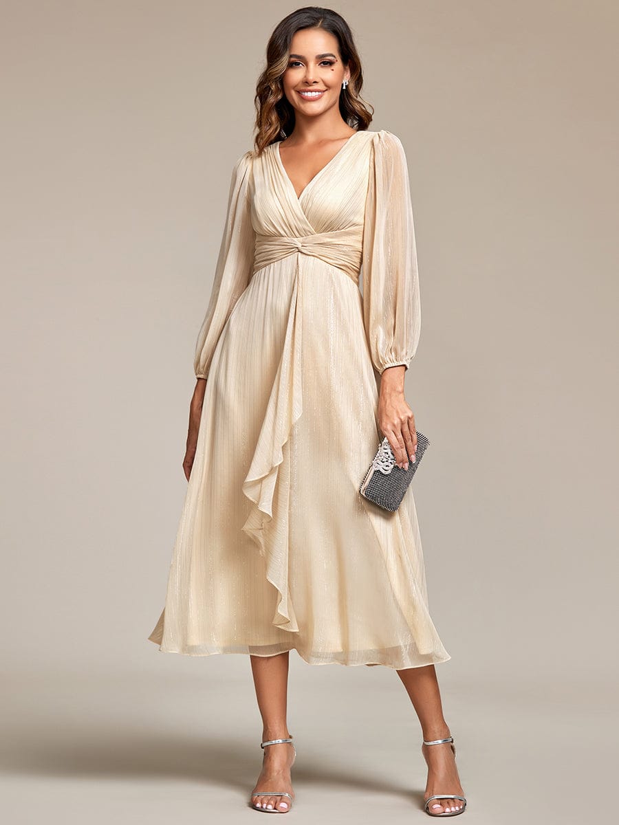 Model wearing a champagne Weitese shimmering A-line evening dress with sheer long sleeves and twist knot detail.