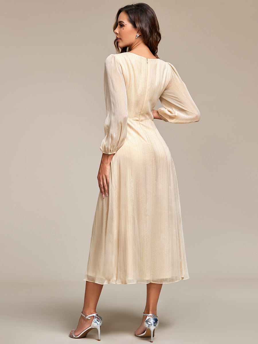 Close-up of the twist knot bodice and sheer long sleeve on the champagne Weitese evening dress.
