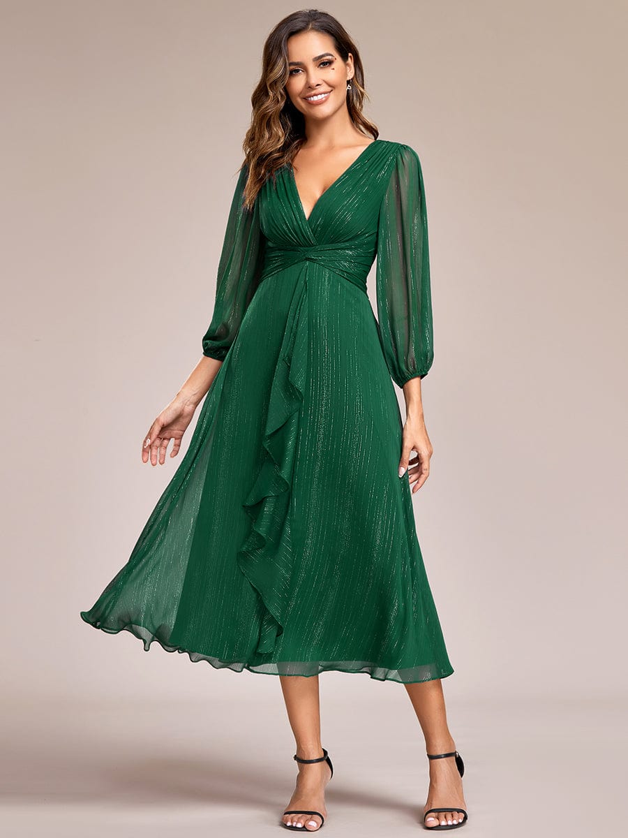 Model wearing a dark green Weitese shimmering A-line evening dress with sheer long sleeves.