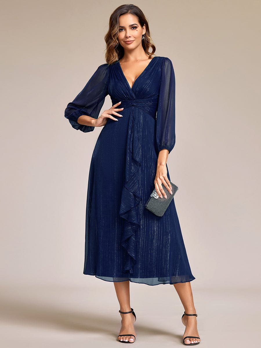 Model wearing a navy blue Weitese shimmering A-line evening dress with sheer long sleeves.