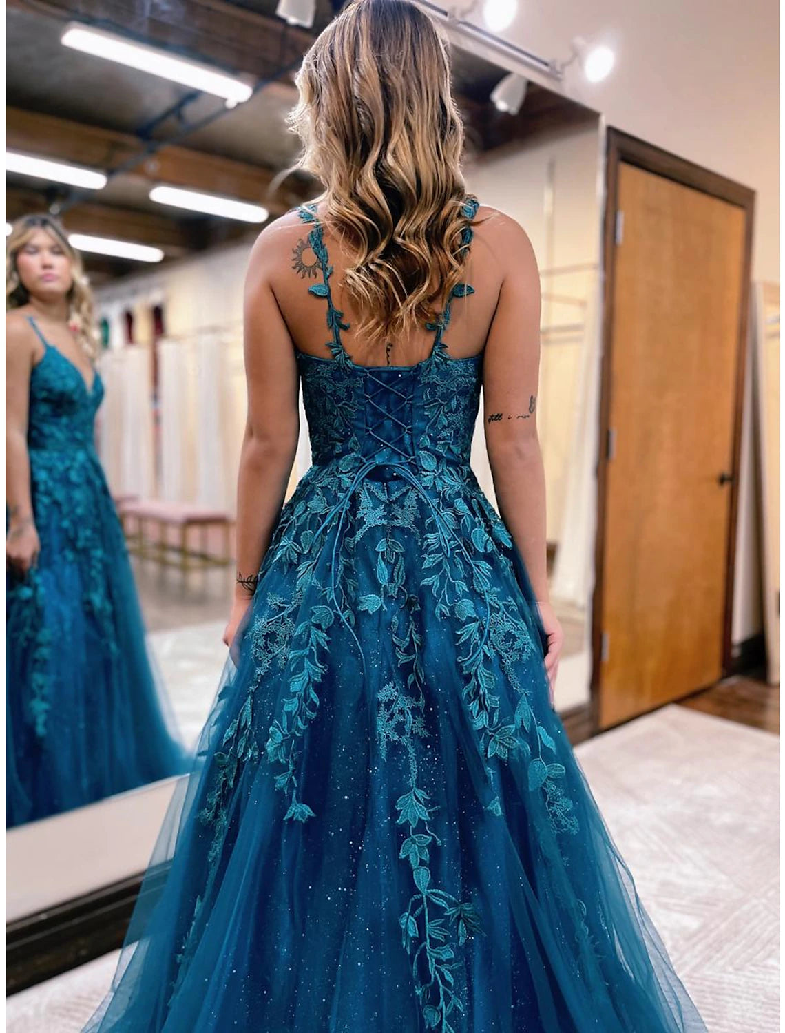 Close-up of the glitter appliques on the tulle fabric of the Weitese prom dress.