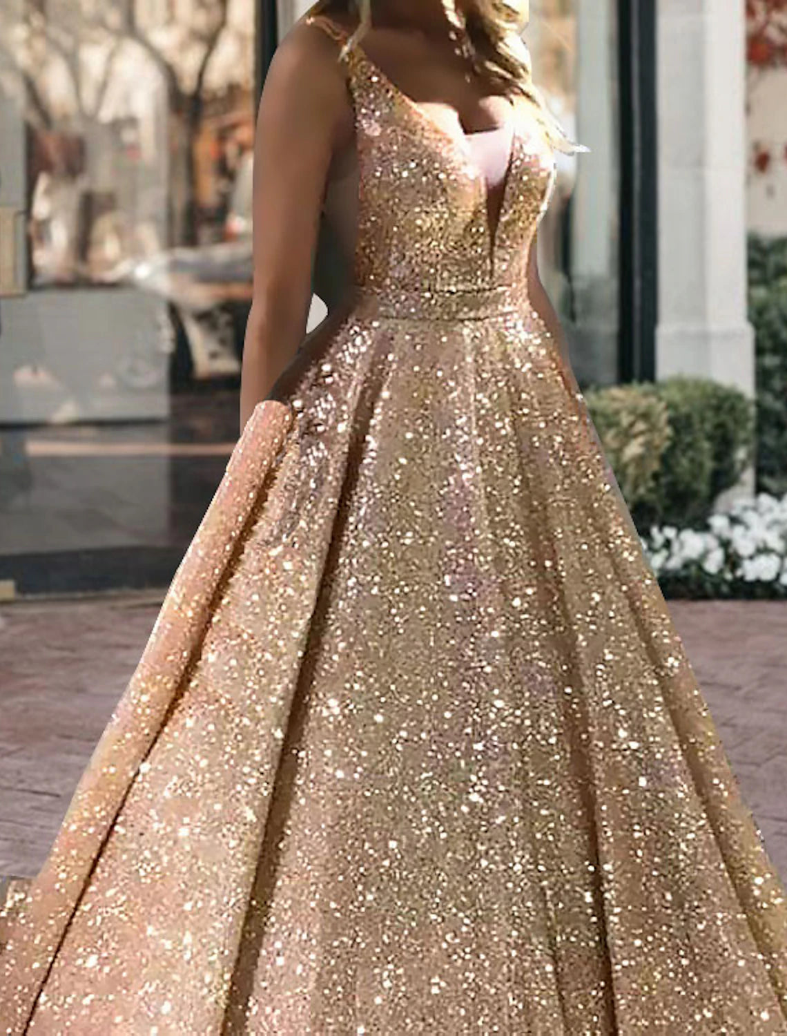 Close-up of the sparkling fabric and sequin embellishments on the black gown.