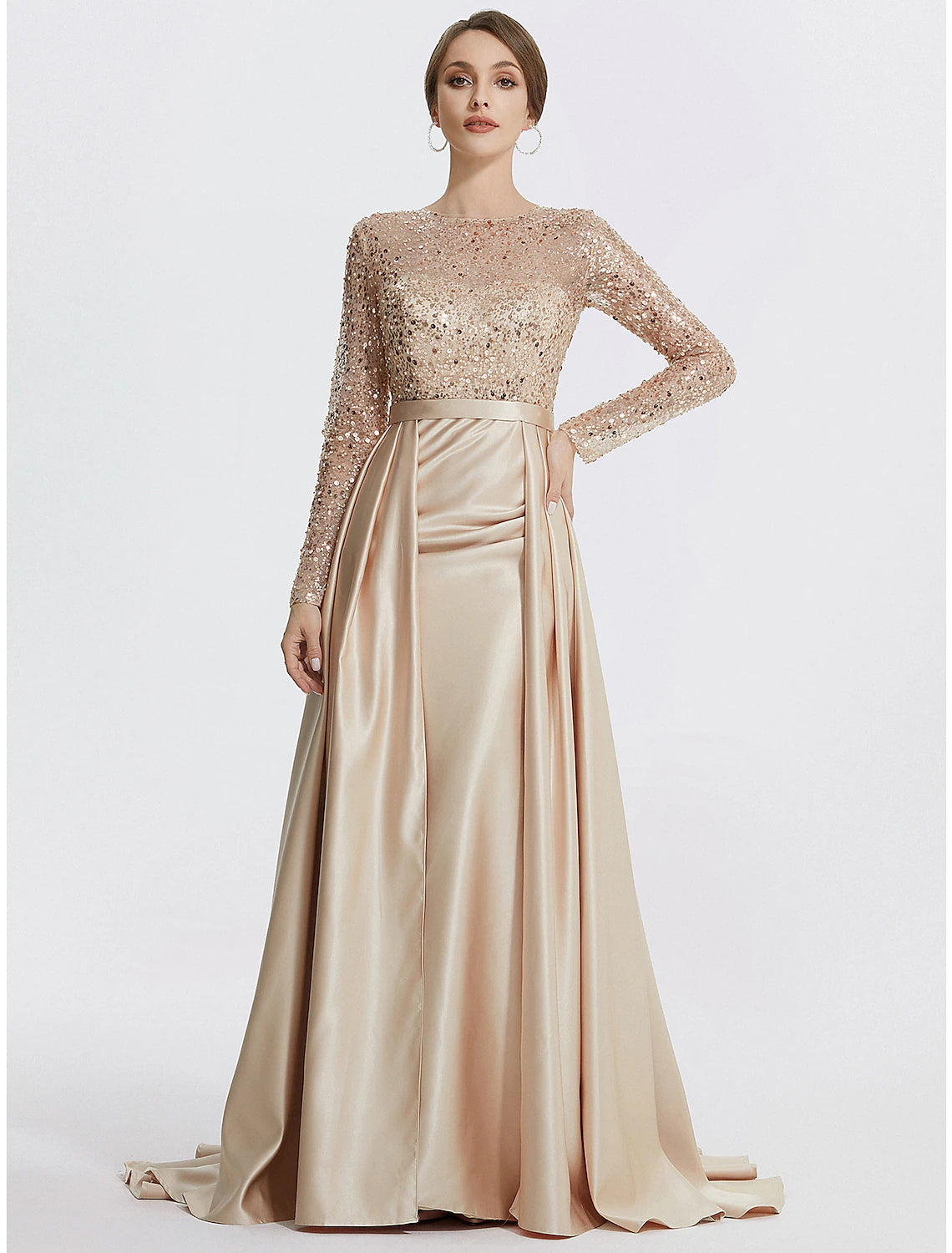 Woman wearing a sparkling long sleeve mermaid trumpet evening gown.