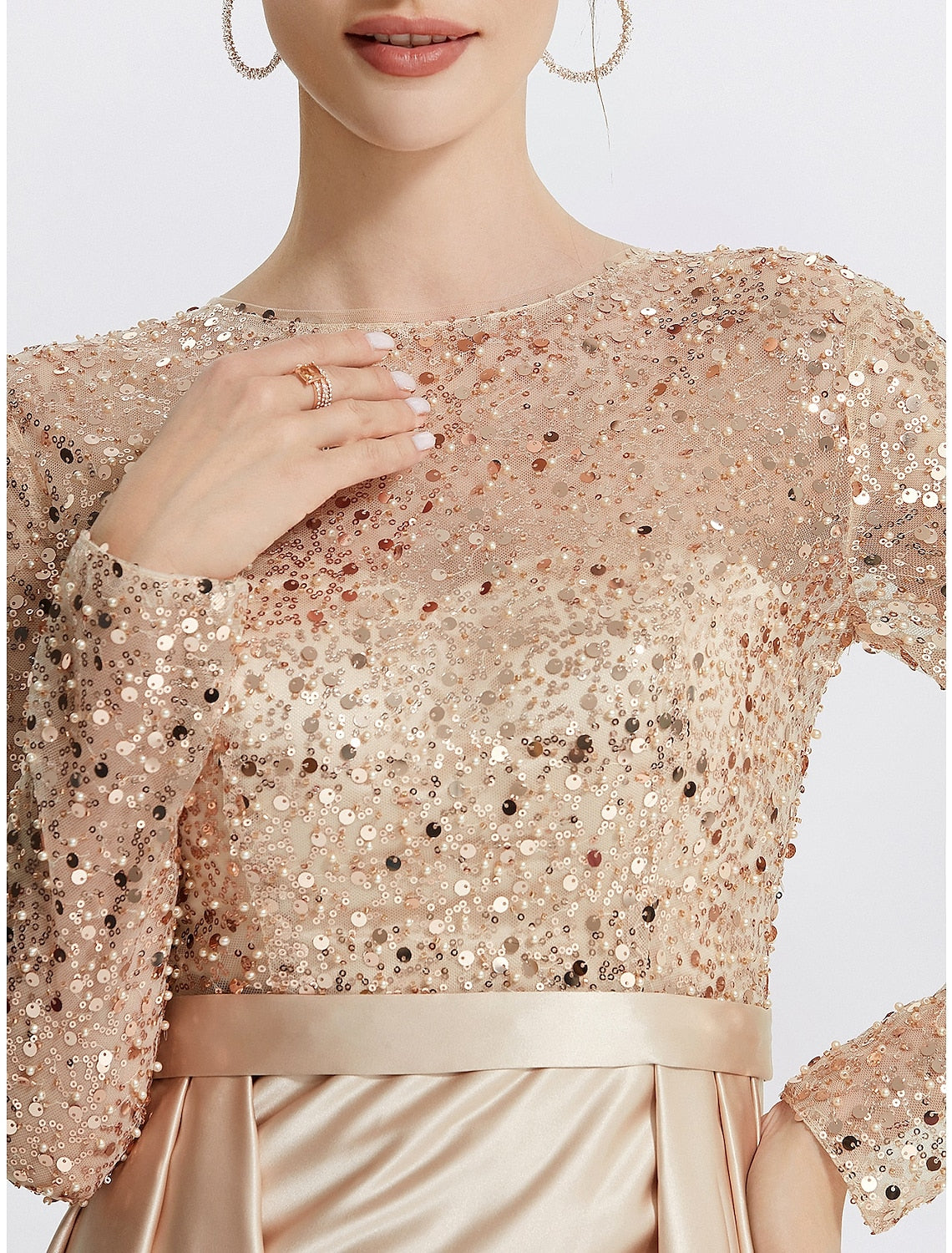 Side profile of a woman in a glitter mermaid prom gown.