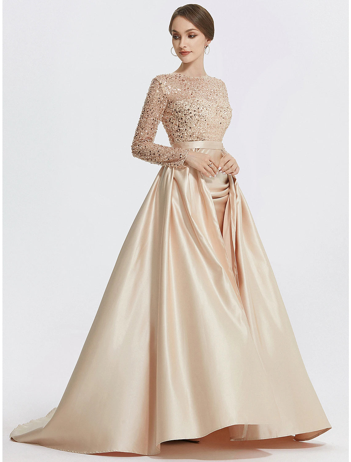 Close-up of the sequined fabric on the long sleeve evening dress.
