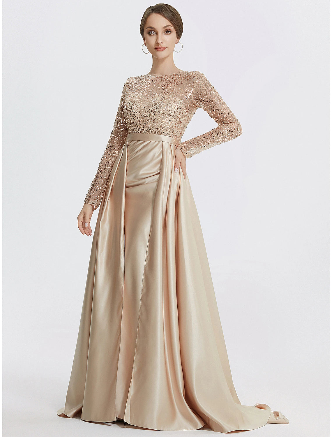 Woman posing in a floor length trumpet formal dress.