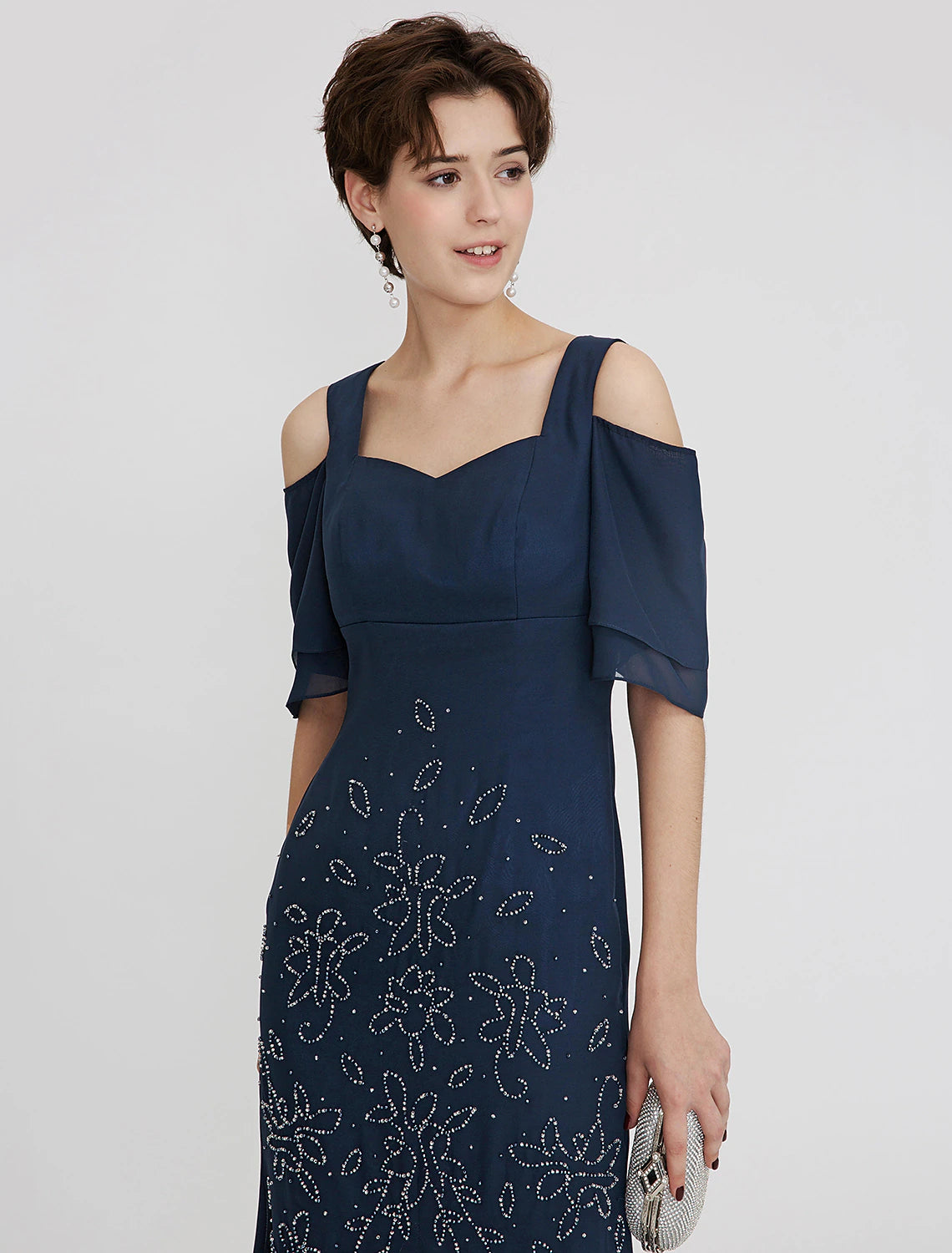 Weitese tea length cocktail dress showcasing chiffon fabric and pleats.