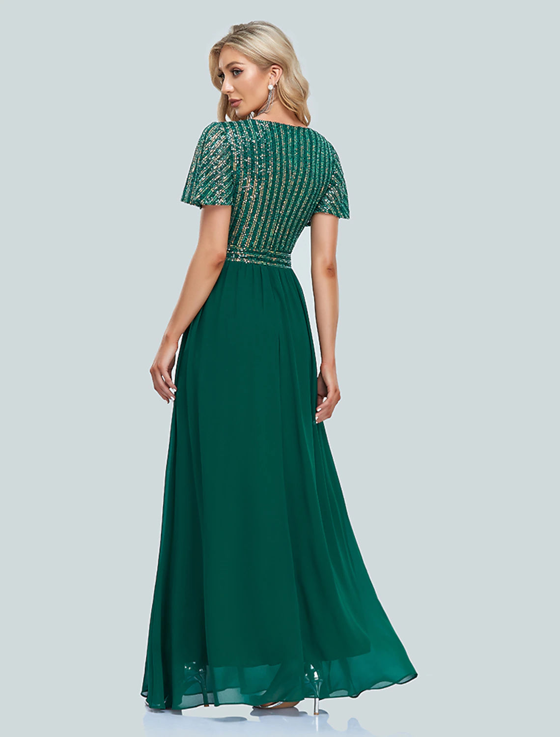 Side view of a woman in a sequined mermaid floor-length dress.