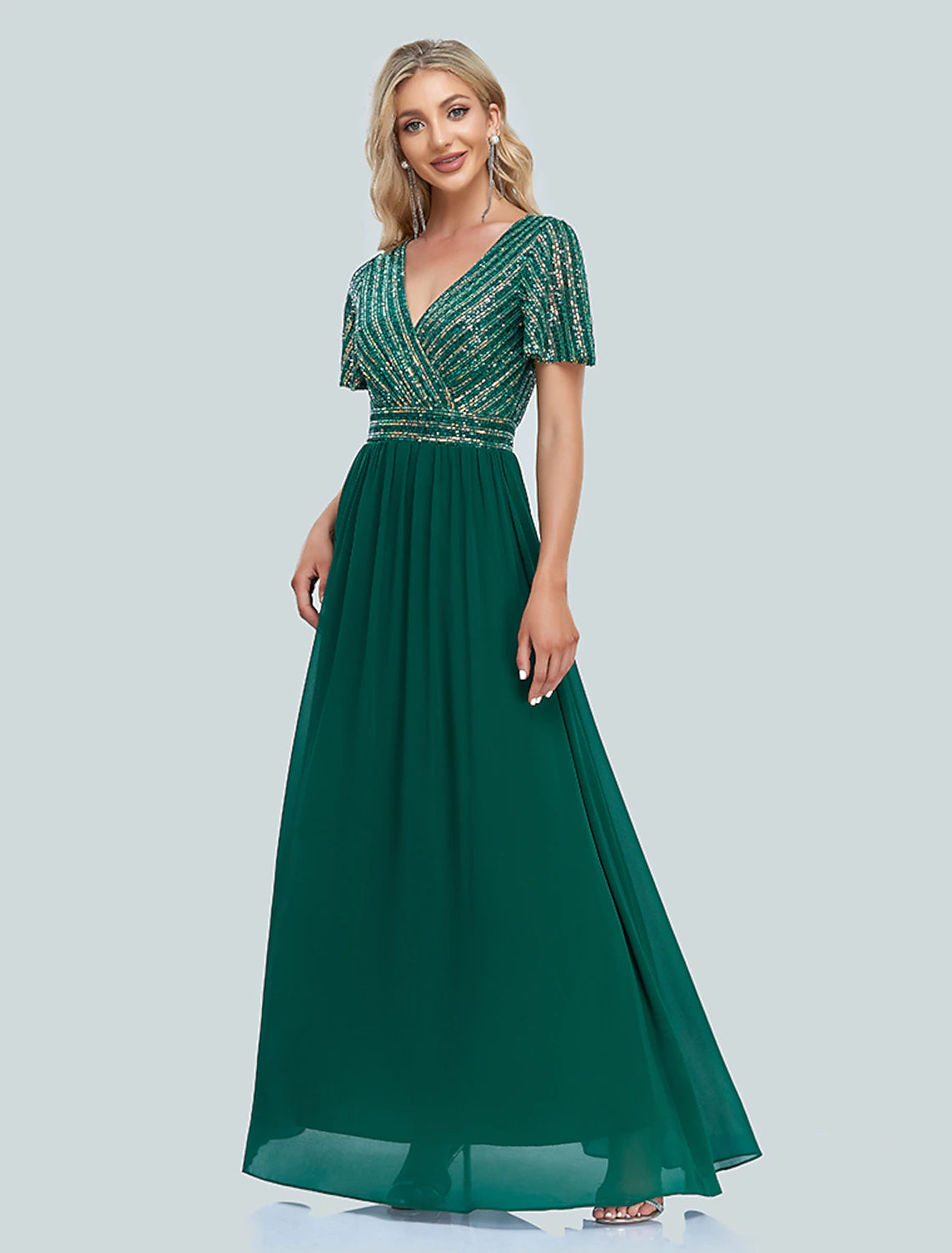 Woman posing gracefully in a short-sleeve sequined mermaid dress.