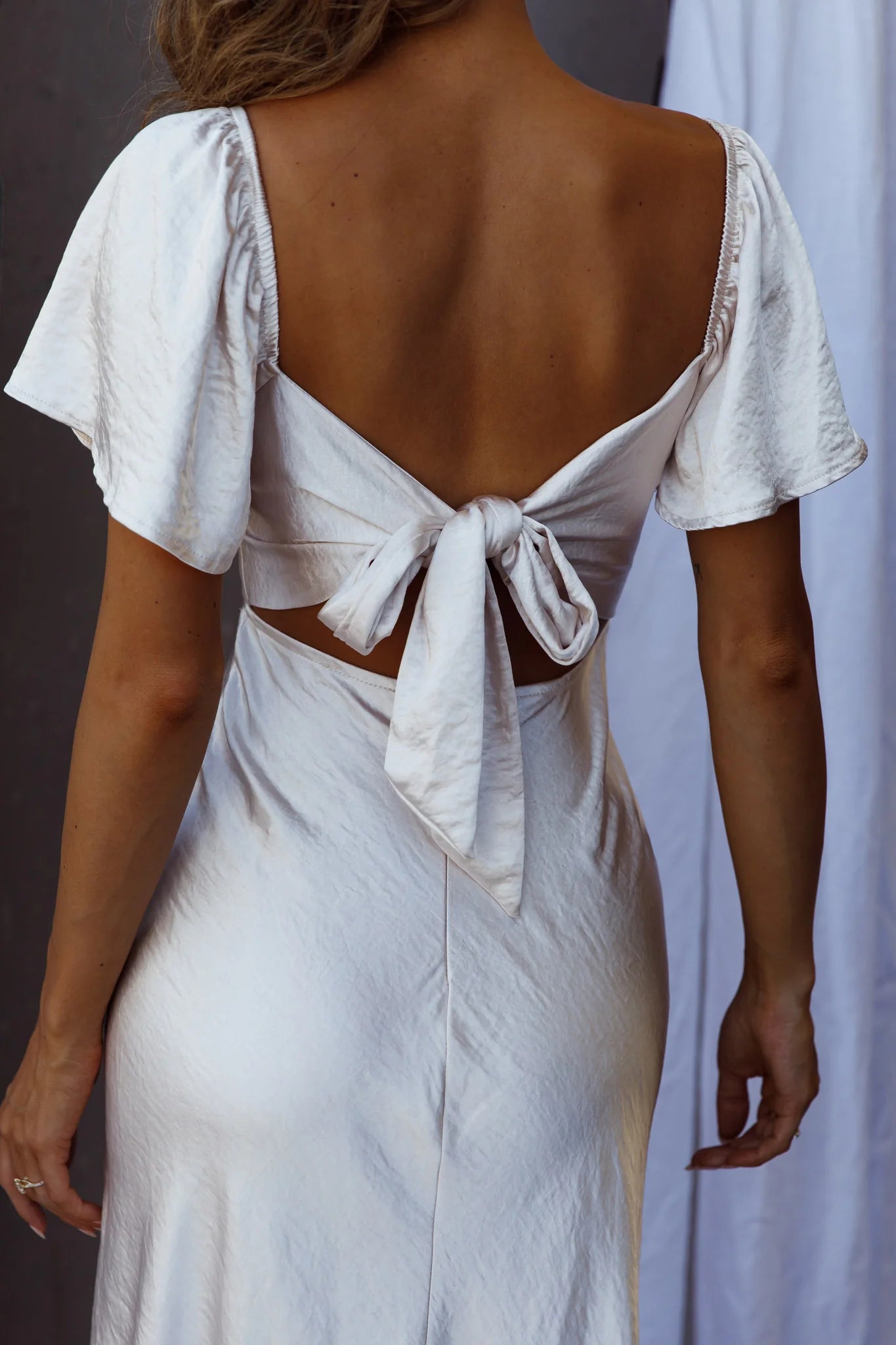 Weitese Dress Elegant Peach Satin Dress Off Shoulder Neck Flutter Sleeve Detail Asymmetric Slit and Midi Length Prom Dress