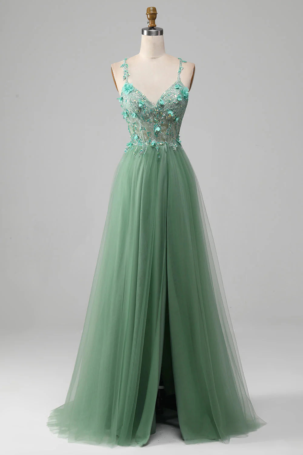 Robe de bal trapèze verte scintillante à bretelles spaghetti et corset avec applications